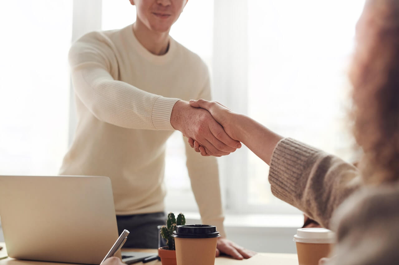 A contractor and a client shaking hands