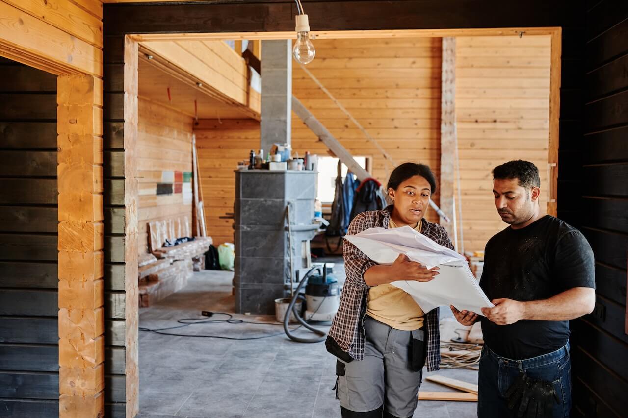 A builder explaining plans with a client